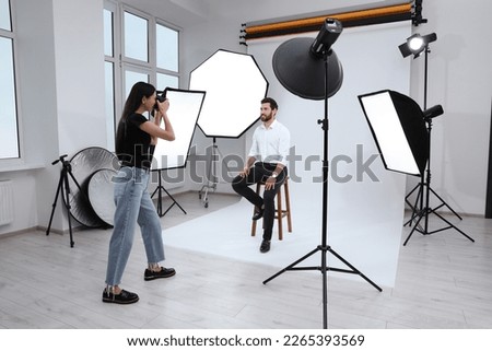 Handsome model posing for professional photographer in studio