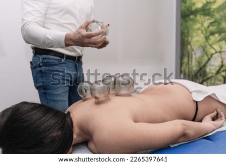 Traditional Chinese medicine acupuncture cupping therapy treatment for pain reliever at back by doctor Royalty-Free Stock Photo #2265397645