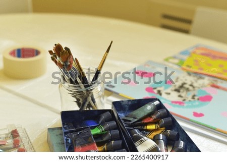 Acrylic paints and brushes on the table. Artist's workplace