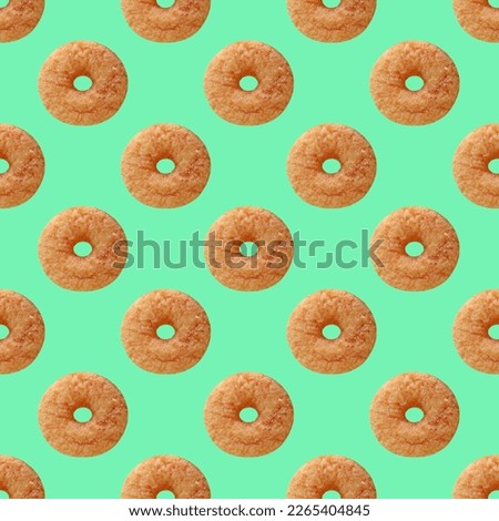Seamless Pattern of Delectable Cinnamon Doughnut on Mint Green Colored Background Royalty-Free Stock Photo #2265404845