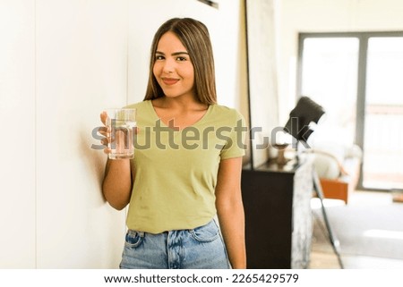 pretty latin woman with a water glass at home