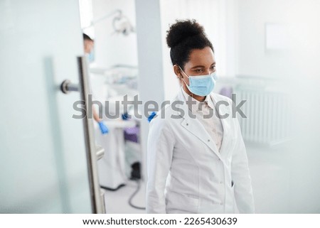 African American female dentist working at dental clinic. Copy space.