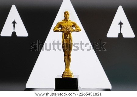 Hollywood Golden Oscar Academy award statue on white and black. Success and victory concept.