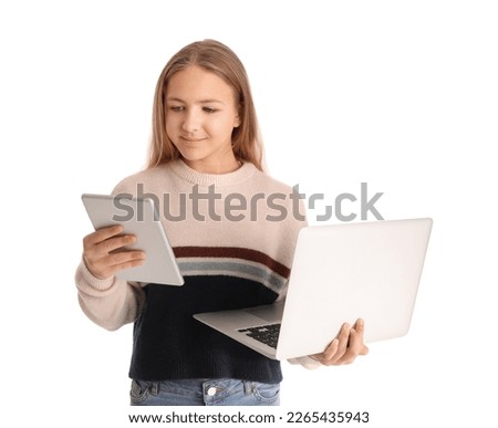 Little girl with laptop and tablet computer on white background