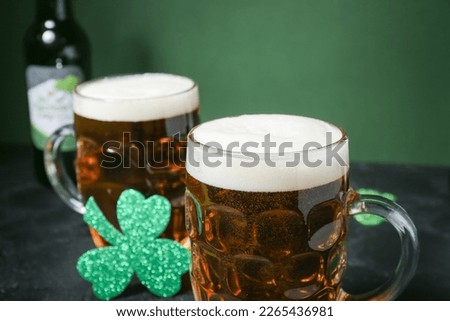 Glasses of beer on dark table, closeup. St. Patrick's Day celebration