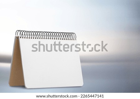 Blank desk office calendar and notebook on table.