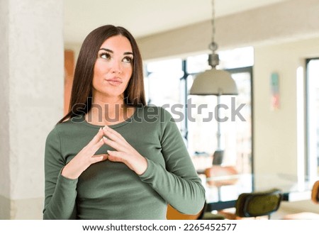 young adult pretty woman scheming and conspiring, thinking devious tricks and cheats, cunning and betraying Royalty-Free Stock Photo #2265452577