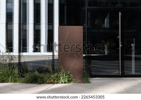 Signboard mockup in the urban environment, with floral elements, empty space to display your advertising or branding campaign