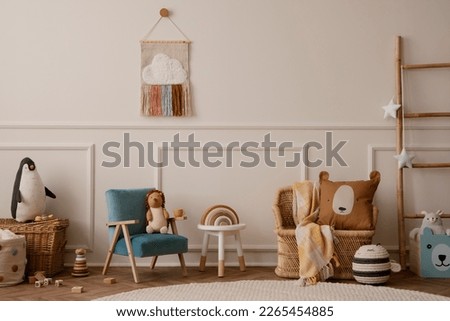 Creative composition of living room interior with blue armchair, coffee table, plush toys, beige wall with stucco, round rug, wooden block, braided basket and personal accessories. Home decor Template