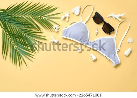 beach accessories on a colored background top view.