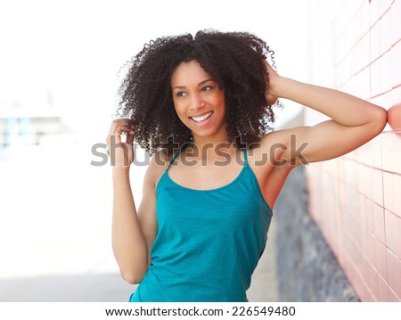 Close up portrait of a young african american woman laughing outdoors