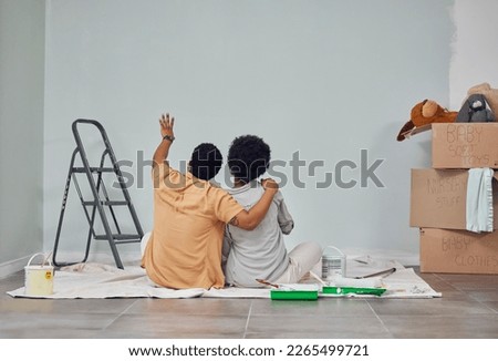 Planning, wall or black couple pointing in home renovation, diy or house remodel together on floor. Back view, painting or African man loves talking or working with teamwork in decoration with woman Royalty-Free Stock Photo #2265499721
