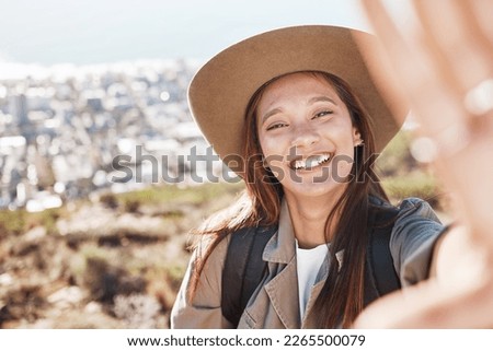 Portrait, woman and selfie in nature for travel, relax and hiking against city background. Face, girl and fitness influencer live streaming for social media, blog or post, smile and profile picture