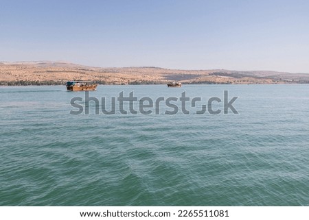 Sea of Galilee showing two boats and the hills in the background.