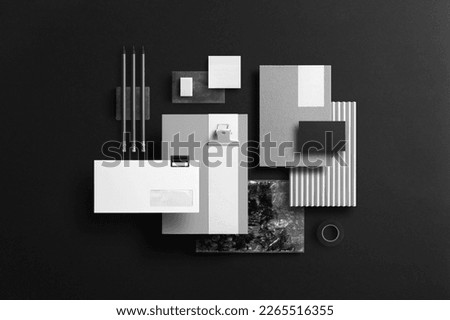 Branding stationery mockup template, top-up view, black background, real photo, business card, envelope, letterhead, notepad. Blank isolated on a black background to place your design. Royalty-Free Stock Photo #2265516355
