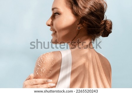 Woman put a natural  white salt scrub to her shoulder  Royalty-Free Stock Photo #2265520243