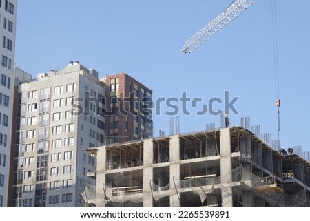 Construction site background. Hoisting cranes and new multi-storey buildings. I.ndustrial background