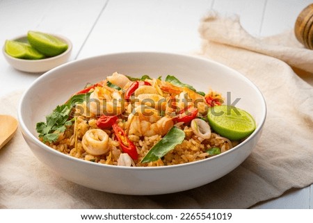 Seafood Tom Yum Fried Rice,Stir fried rice with shrimp and squid with chilli sauce on white plate Royalty-Free Stock Photo #2265541019