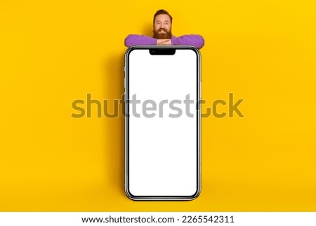 Full size photo of positive nice man huge empty space telephone display cover body isolated on yellow color background
