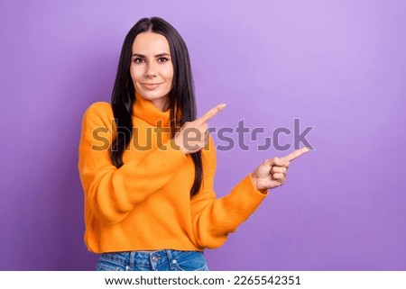 Portrait of gorgeous positive girl direct fingers empty space advert isolated on purple color background