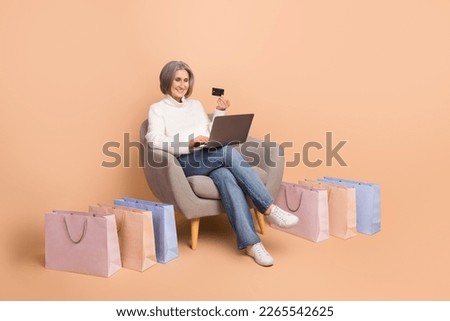 Full length photo of pretty sweet woman wear knitted pullover buying bargains gadget empty space isolated beige color background