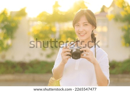 Asian woman traveler using camera. Asia summer tourism concept