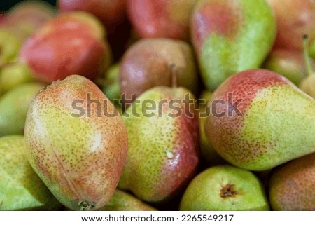 Full frame close-up on a stack of pears for sale on a market stall.