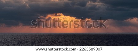 Dramatic Colorful Sunset Sky over Mediterranean Sea. Clouds with Sunrays. Cloudscape Nature Background. Royalty-Free Stock Photo #2265589007