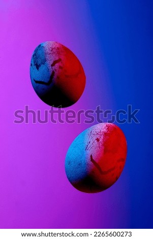 Aesthetic composition with flying chicken eggs on a blue pink background. Creative poster for Easter in veri peri colors