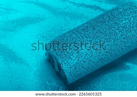 Abstract artistic background. Blue paint color and part of the roller. Smears of paint. Modern Art. Royalty-Free Stock Photo #2265601325
