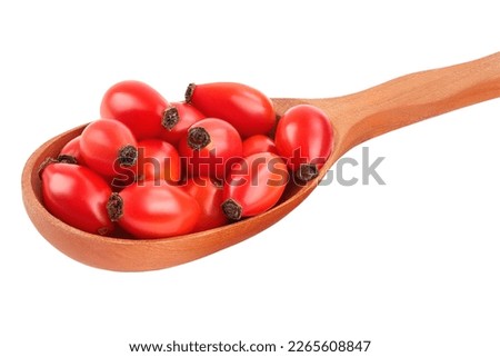 Rose hip in wooden spoon isolated on a white background with full depth of field