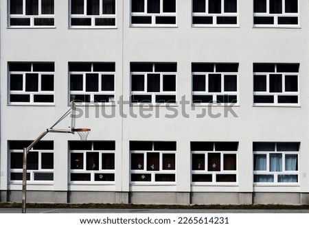 Basketball hoop in front of a white building