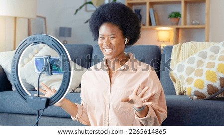 Beauty influencer filming a makeup tutorial at home. Young female blogger live streaming a broadcast online with ring light for a vlog channel. Recording a fun podcast for followers on social media Royalty-Free Stock Photo #2265614865