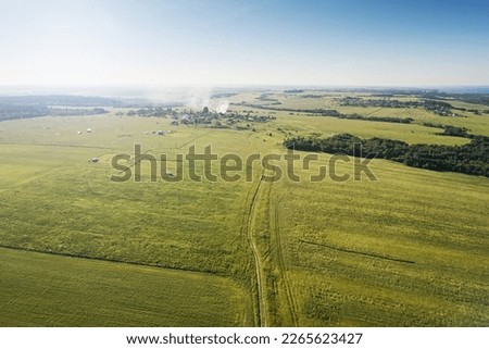 Top view of agricultural fields against a blue sky on a bright sunny day. Aerial photography