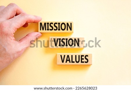 Mission vision values symbol. Concept words Mission Vision Values on wooden blocks on a beautiful white table white background. Businessman hand. Business mission vision values concept. Copy space.