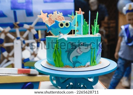 birthday cake in blue color on a marine theme with a shark