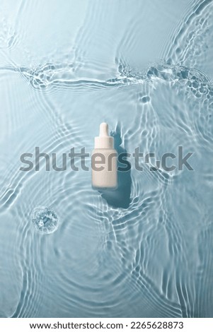 Skin care product mock up on water surface. Water ripples from top angle. Flat lay of ocean waves with product in centre. 