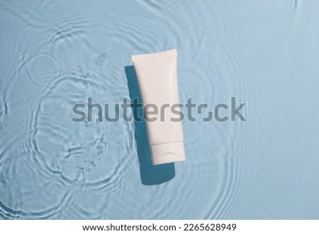 Skin care product mock up on water surface. Water ripples from top angle. Flat lay of ocean waves with product in centre. 