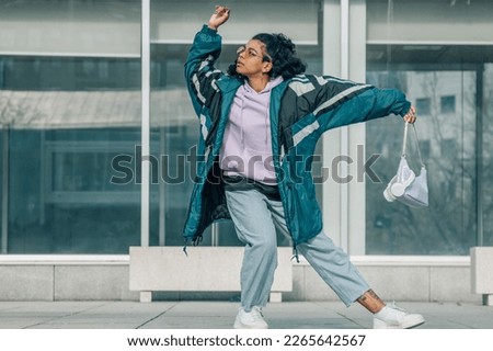 urban girl dancing in the street Royalty-Free Stock Photo #2265642567