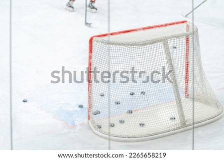 ice hockey goal with pucks, during a hockey players training session