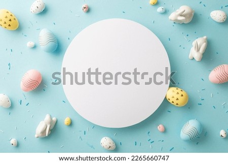 Easter concept. Top view photo of white circle ceramic easter bunnies colorful eggs and sprinkles on isolated pastel blue background with copyspace