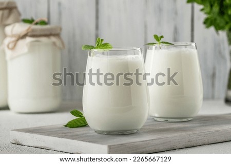 Glass cup of Turkish traditional drink ayran , kefir or buttermilk made from yogurt, healthy food Royalty-Free Stock Photo #2265667129