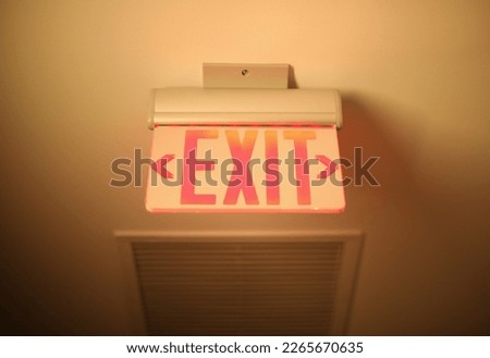Hallway exit sign vibrant in corridor showing evacuation during emergency neon