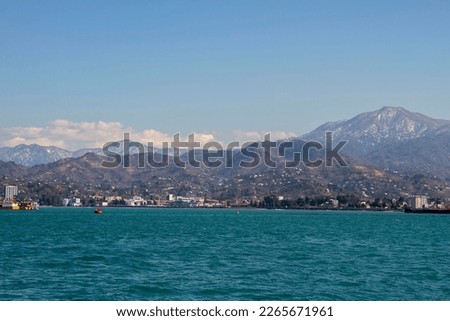 View of the mountains from the embankment of Batumi in winter on a clear day Royalty-Free Stock Photo #2265671961