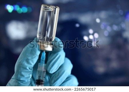 Medical personnel filling a syringe needle with generic vaccine booster from vial - flu shot RSV covid Royalty-Free Stock Photo #2265675017