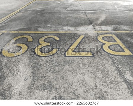 concrete apron area with text "B737" pattern texture background