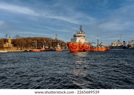 Port of Gdansk, Baltic Sea, the tug shown in the picture is a multi-purpose offshore vessel - a supply ship, an ocean tug and an anchor handling unit. The ship is 69 meters long, its total tonnage is 