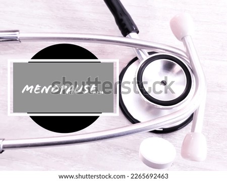 Menopause term with stethoscope and drugs. Medical Conceptual image.