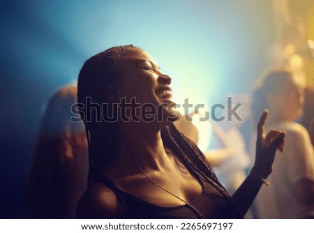 A young girl partying in a club and moving to the music. This concert was created for the sole purpose of this photo shoot, featuring 300 models and 3 live bands. All people in this shoot are model Royalty-Free Stock Photo #2265697197