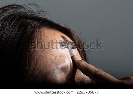 the symbol of a cross made of ashes placed on a woman's forehead during Ash Wednesday celebrations, Medan, February 23, 2023 Royalty-Free Stock Photo #2265705879